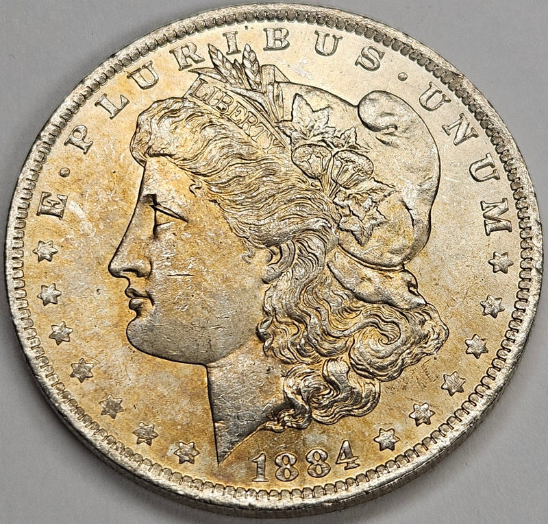 1884-O Morgan Dollar Choice BU+ Golden Toning
