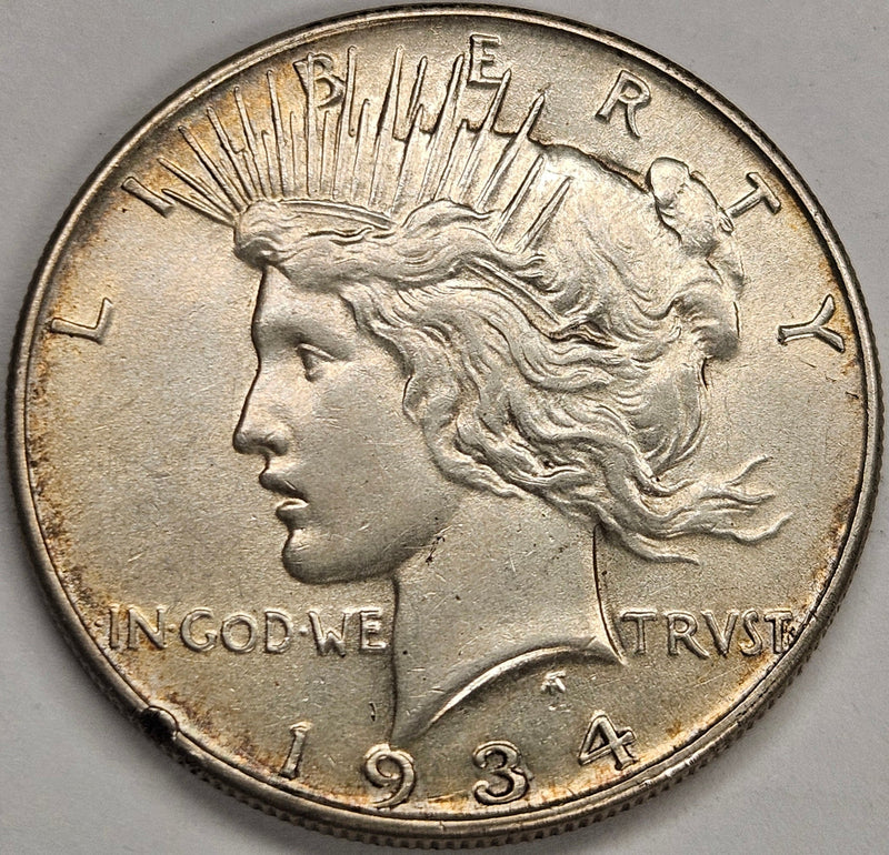 1934 Peace Dollar AU rim hit